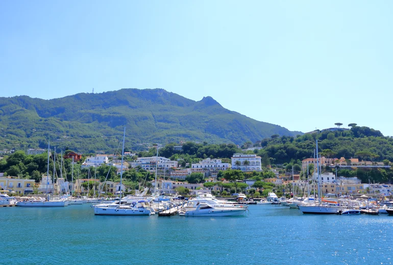 Catamaran sailing past Sardinian coastline
