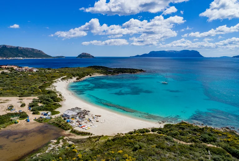 Catamaran in Sardinian bay at golden hour
